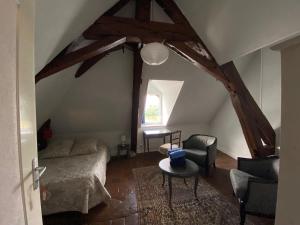 a bedroom with a bed and a table in a room at Le Motu Loire in Chaumont-sur-Loire +7 photos