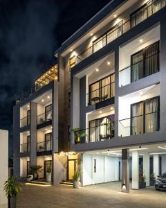 an apartment building at night with a car parked in front at Grey Assets - Apartment 2 in Spintex