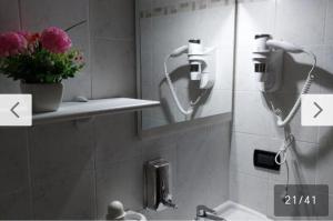 a bathroom with a sink and a mirror and a phone at B&B Albachiara in Otranto +44 photos