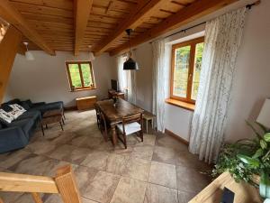 a living room with a table and a couch at Apartmán za Holubnicou in Spišská Nová Ves