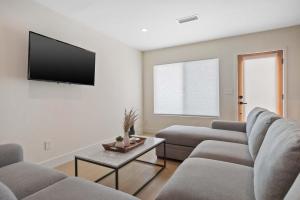 a living room with two couches and a flat screen tv at New Listing Valley Villa by Colby & Conrad in Winnetka