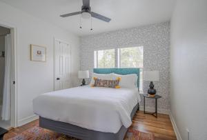 a bedroom with a large white bed and a window at Spacious 6 Bed 6 Bath Duplex with a Pool in Houston +36 photos