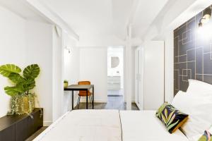 a bedroom with a bed and a table at Convinient souplex basement 5mn near métro and Montmartre in Paris