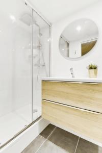a bathroom with a sink and a mirror at Convinient souplex basement 5mn near métro and Montmartre in Paris