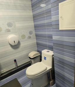 a bathroom with a toilet and a sink at Queen Mongolia Guest House in Dzuunmod
