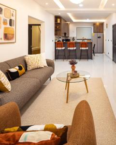 a living room with a couch and a table at Grey Assets - Apartment 3 in Spintex