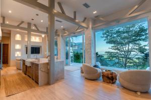 a large living room with a kitchen and a large window at The Retreat Costa Rica - Wellness Resort & Spa in Atenas
