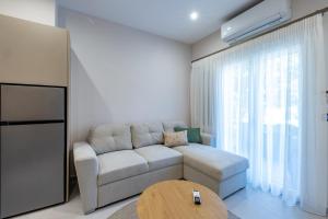 a living room with a couch and a table at LV Apartments Ioannina in Anatolí