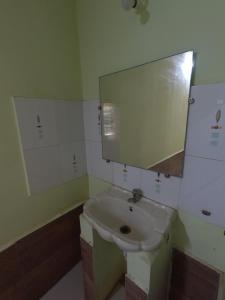 a bathroom with a sink and a mirror at Travel Moody Beach touch Homestay & Campsite in Dapoli +58 photos