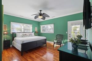a bedroom with green walls and a bed with a ceiling fan at AB15: 15 Atlantic Beach in Kiawah Island +48 photos