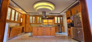 a large kitchen with wooden cabinets and stainless steel appliances at Premium Residence in Maputo