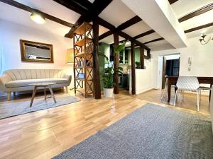 a living room with a couch and a table at Baumeisterhaus Suite in Bad Hersfeld