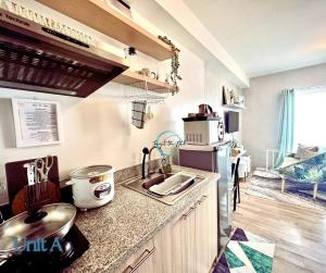 a kitchen with a sink and a counter top at Lovely Studio Condominiums at Mesavirre Garden Residences Bacolod in Bacolod