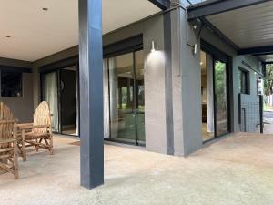 a house with glass doors on a patio at Bushview cottage 