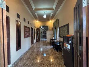 a hallway with a table and chairs in a building at NOWORRIES Banyuwangi in Banyuwangi