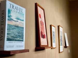 a row of framed pictures hanging on a wall at NOWORRIES Banyuwangi in Banyuwangi