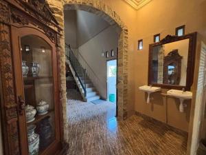 a hallway with two sinks and a staircase in a house at NOWORRIES Banyuwangi in Banyuwangi