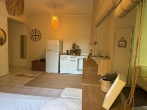 a kitchen with a white refrigerator and a counter top at Chateau de mont-vert in Saint-Zacharie