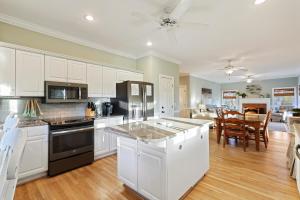 a kitchen with white cabinets and a counter top at SM08: 8 Silver Moss in Kiawah Island