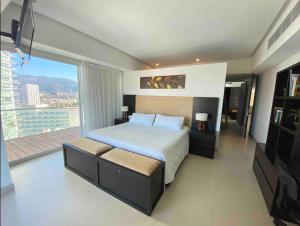 a bedroom with a large bed and a large window at Icon Vallarta in Puerto Vallarta +61 photos
