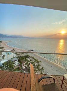 a balcony with a view of the beach and the ocean at Icon Vallarta in Puerto Vallarta