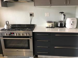 a kitchen with a stove and a blender on the counter at Horizon small holding in Polokwane