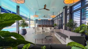 a lobby with a couch and tables and plants at 9 Mossaz skypool 5mins to 1U and Ikea atEmpire City by Light House in Petaling Jaya