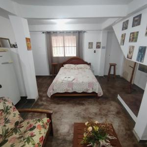 a bedroom with a bed and a couch at Casa em frente a praça principal in Rio das Flores +7 photos