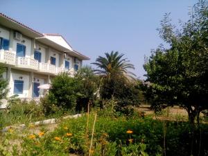 a hotel with a garden in front of a building at Guesthouse Karidia in Skala Eresou +20 photos
