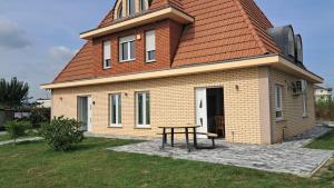 a small house with a table in front of it at Villa Alpine in Valjiosi