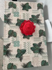 a napkin with a red flower on it at Casetta Silvia in Brindisi