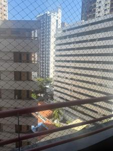 a view of some tall buildings from a balcony at Quarto mobiliado na orla de Iracema in Fortaleza