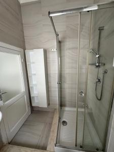 a shower with a glass door in a bathroom at Casetta Silvia in Brindisi