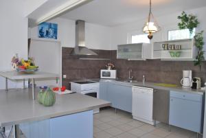 a kitchen with white cabinets and a counter top at la belle étape in Osséja