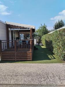 a large deck with a roof on a house at Le SPLENDIDE in Fréjus