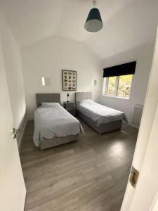 a bedroom with two beds and a window at Magnificent Views over Dungarvan Bay, Ring, Waterford , Panoramic Sea Views, in Dungarvan