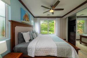 a bedroom with a bed with a ceiling fan at AltaVista 4C 3 bdr Ocean View in Los Suenos in Herradura +35 photos