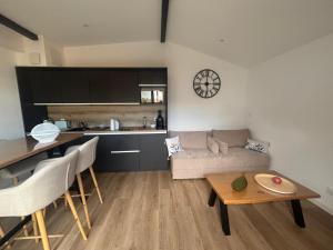 a living room with a couch and a table at DACSE-VILLAGE - Gite 01 in Dax
