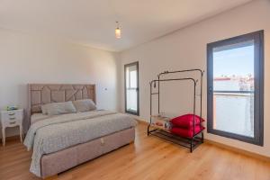 a bedroom with a bed and a large window at Solstice 73 Luffy Air Studio in Casablanca