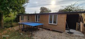 a house with a tennis table in front of it at Chalet Robinson, a 20 km de Disney et 50 de Paris - SNCF in Mortcerf
