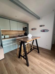 a kitchen with a wooden table in a room at DACSE-VILLAGE - Gite 02 in Dax