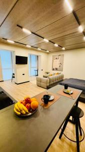 a living room with a table with fruit on it at New Premium LOFT studio in Zhytomyr