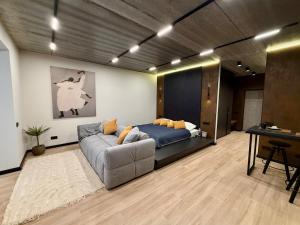 a living room with a couch and a bed at New Premium LOFT studio in Zhytomyr