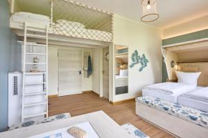 a bedroom with two bunk beds and a table at Wangerland Resort in Wangerland +18 photos