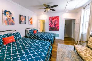 a bedroom with a bed and a ceiling fan at St. Ann Historic Creole Cottage 5 bed-4ba in New Orleans +10 photos