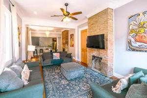 a living room with a couch and a fireplace at St. Ann Historic Creole Cottage 5 bed-4ba in New Orleans