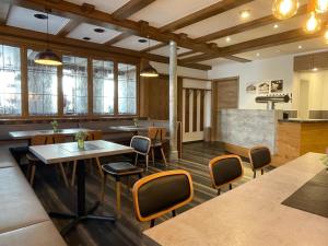 a restaurant with tables and chairs and a counter at Gasthof Hotel Adler Inneringen in Inneringen-Hettingen