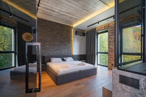 カウナスにあるDesign 2 BD Apartment with Hot Tube by Domviaのレンガの壁、ベッド2台が備わるベッドルーム1室が備わります。