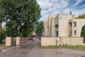 a brick building with a fence in front of it at Design 2 BD Apartment with Hot Tube by Domvia in Kaunas