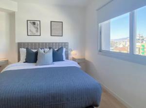 a bedroom with a large bed with a large window at Plateia suite Grigio in Nicosia